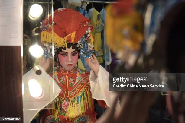 Child prepares backstage prior to a Cantonese opera performance on June 26, 2018 in Hong Kong, China. Thirty-four children from Po Leung Kuk...