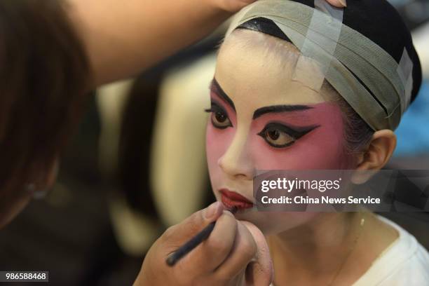 Child prepares backstage prior to a Cantonese opera performance on June 26, 2018 in Hong Kong, China. Thirty-four children from Po Leung Kuk...