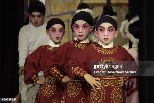 Schoolchildren prepare backstage prior to a Cantonese opera performance on June 26, 2018 in Hong Kong, China. Thirty-four children from Po Leung Kuk...