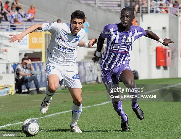 Toulouse's defender Cheik Mbengue vies with Auxerre's forward George Niculae during their French L1 match Toulouse versus Auxerre on April 25, 2010...