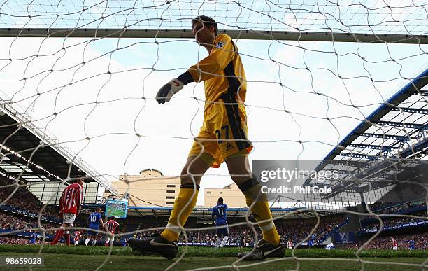 Asmir Begovic of Stoke City looks dejected during the Barclays Premier League match between Chelsea and Stoke City at Stamford Bridge on April 25,...