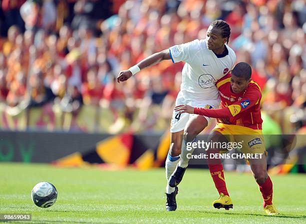 Lens's French forward Kevin Monnet-Paquet vies with Valenciennes's defender Gaetan Bong during the French L1 football match Lens vs Valenciennes on...