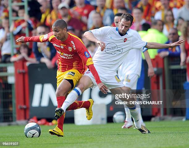 Lens's French forward Kevin Monnet-Paquet vies with Valenciennes's French forward Gregory Pujol during the French L1 football match Lens vs...
