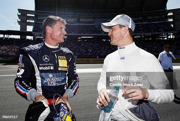 David Coulthard of Great Britain and Mücke Motorsport AMG Mercedes is seen with Ralf Schumacher of Germany and Team HWA AMG Mercedes before they both...