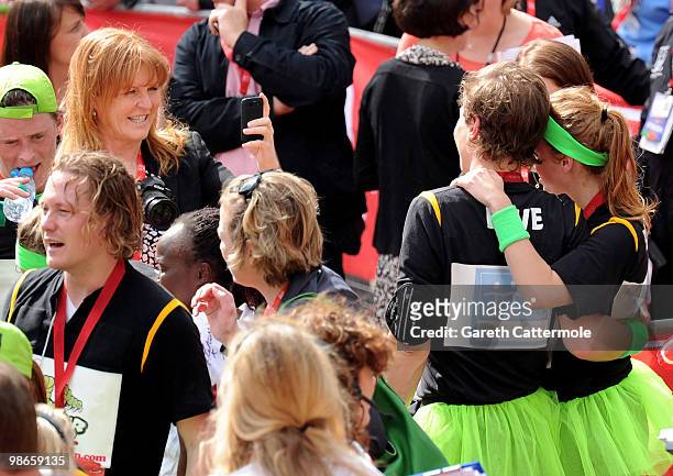 Sarah Ferguson takes a photo of her daughter Princess Beatrice and her boyfriend Dave Clark attend the Virgin London Marathon on April 25, 2010 in...