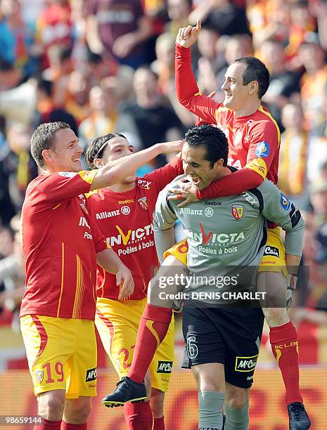 Lens's French forward Kevin Monnet-Paquet celebrates with teammates after scoring during the French L1 football match Lens vs. Valenciennes on April...