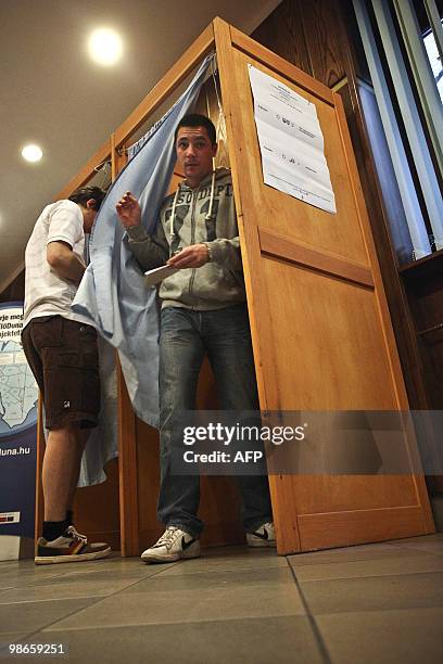 Locals prepare their ballot at a polling station of Budapest on April 25, 2010 during the second round of the general election. A center-right party...