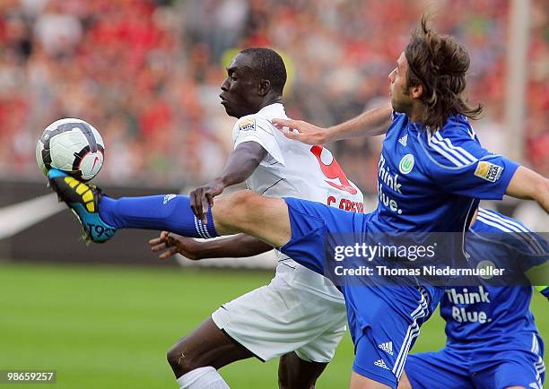 Papiss Cisse of Freiburg fights for the ball with Andrea Barzagli of Wolfsburg during the Bundesliga match between SC Freiburg and VfL Wolfsburg at...