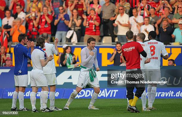 Heiko Butscher of Freiburg celebrates with his team mates after the Bundesliga match between SC Freiburg and VfL Wolfsburg at Badenova Stadium April...