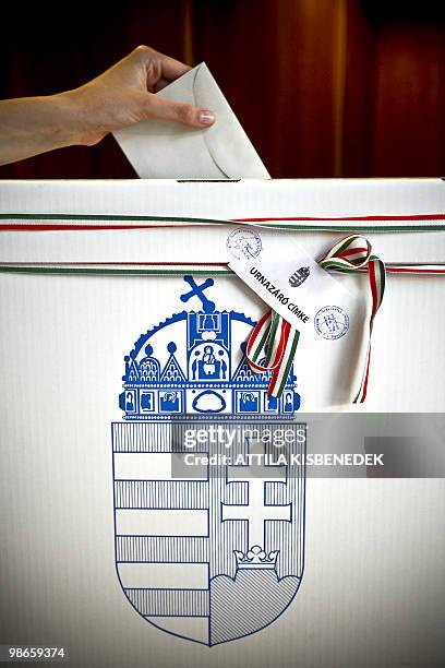 Person puts her ballot at a polling station of Budapest on April 25, 2010 during the second round of the general election. A center-right party...