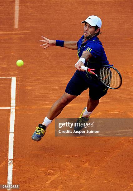 Fernando Verdasco of Spain jumps to play a backhand to Robin Soderling of Sweden during the final match on day seven of the ATP 500 World Tour...