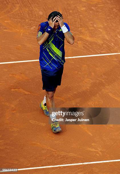 Fernando Verdasco of Spain holds in head after celebrating his match point over Robin Soderling of Sweden during the final match on day seven of the...