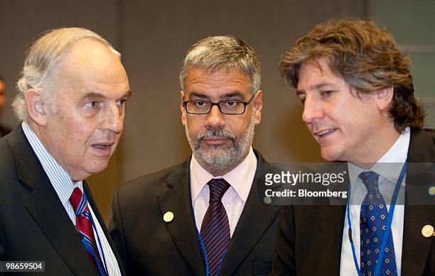 Roberto Feletti, vice-president of Banco de la Nacion SA, center, listens to Amado Boudou, economy minister of Argentina, center, talk to during the...