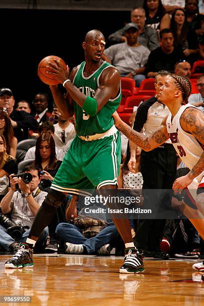 Kevin Garnett of the Boston Celtics drives against Michael Beasley of the Miami Heat in Game Four of the Eastern Conference Quarterfinals during the...