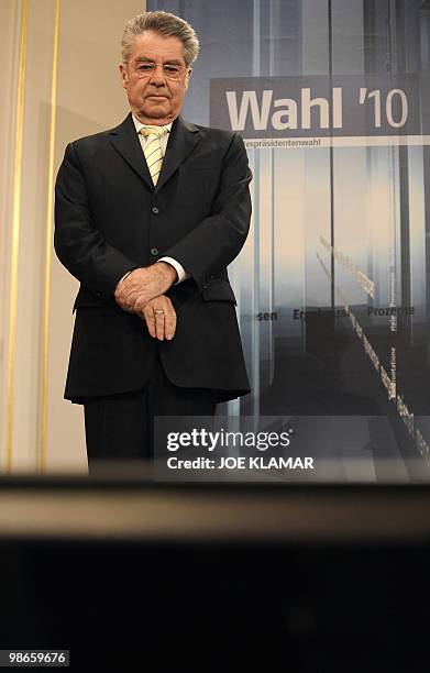 Austrian President re-elected Heinz Fischer watches a TV announcing the results in Austria's Presidential Elections 2010 headquarters in Hoffburg...