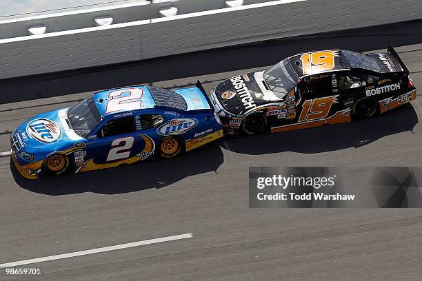 Kurt Busch, driver of the Miller Lite Dodge, gets bump drafted by Elliott Sadler, driver of the Stanley/Bostitch Ford, during the NASCAR Sprint Cup...