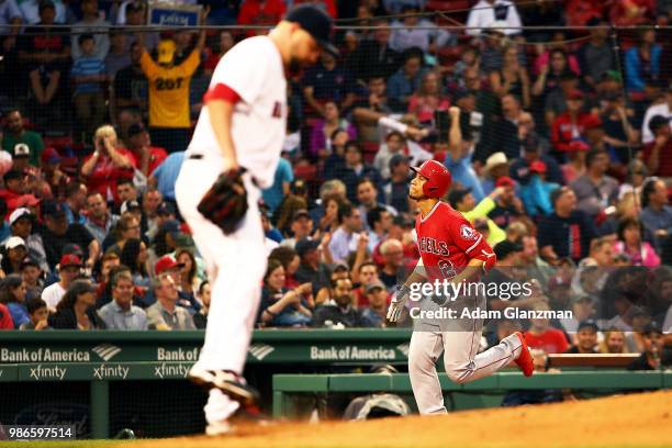 Brian Johnson of the Boston Red Sox looks on as Andrelton Simmons of the Los Angeles Angels rounds the bases after hitting a solo home run in the...