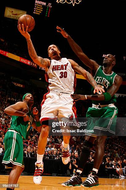 Michael Beasley of the Miami Heat shoots against Kevin Garnett of the Boston Celtics in Game Four of the Eastern Conference Quarterfinals during the...