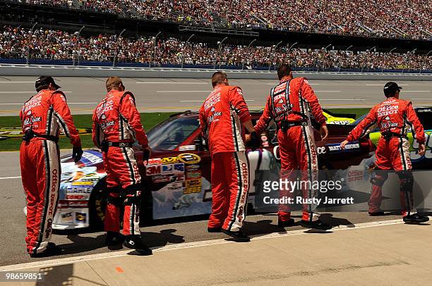 Tony Stewart, driver of the Olds Spice Matterhorn Chevrolet, high fives his crew members on the grid prior to the start of the NASCAR Sprint Cup...
