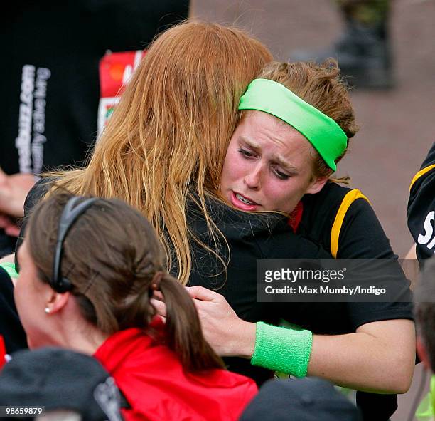 An emotional looking HRH Princess Beatrice embraces her mother Sarah Ferguson, The Duchess of York after completing the Virgin London Marathon as...