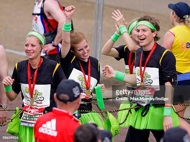 Holly Branson, HRH Princess Beatrice of York and Dave Clark celebrate after completing the Virgin London Marathon as part of the 'Caterpillar Run'...