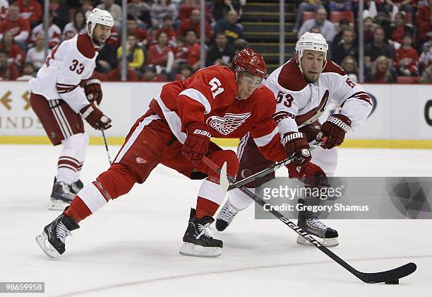 Valtteri Filppula of the Detroit Red Wings tries to get around the stick of Derek Morris of the Phoenix Coyotes during Game Six of the Western...