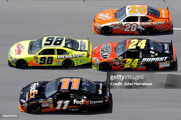 Denny Hamlin, driver of the FedEx Express Toyota, races Paul Menard, driver of the Turtle Wax/Menards Ford, Jeff Gordon, driver of the DuPont...
