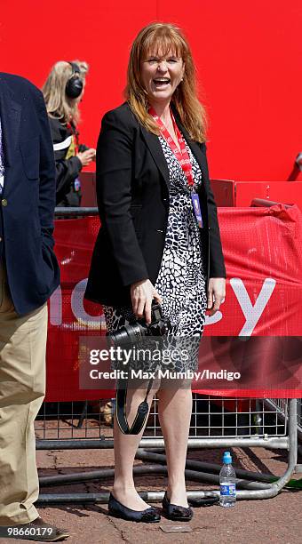 Sarah Ferguson, The Duchess of York takes photographs of runners as she waits for daughter HRH Princess Beatrice of York to complete the Virgin...