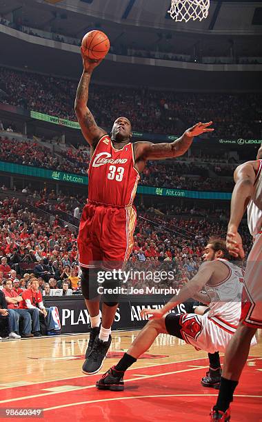 Shaquille O'Neal of the Cleveland Cavaliers goes to the basket over Joakim Noah of the Chicago Bulls in Game Four of the Eastern Conference...