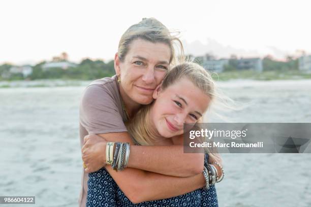 mother and daughter embracing at the beach - st simons island stock pictures, royalty-free photos & images