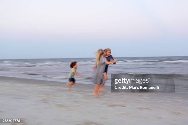 children playing at the beach - marc romanelli stock pictures, royalty-free photos & images