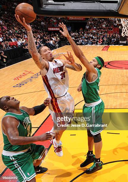 Michael Beasley of the Miami Heat shoots against Rasheed Wallace of the Boston Celtics in Game Four of the Eastern Conference Quarterfinals during...