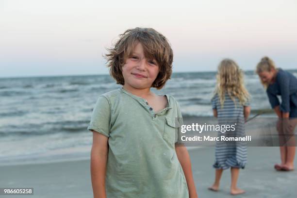 portrait of 4 year old boy at the beach - marc romanelli stock pictures, royalty-free photos & images