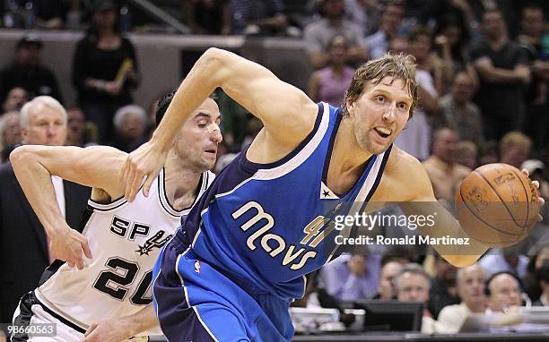 Forward Dirk Nowitzki of the Dallas Mavericks dribbles the ball past Manu Ginobili of the San Antonio Spurs in Game Three of the Western Conference...