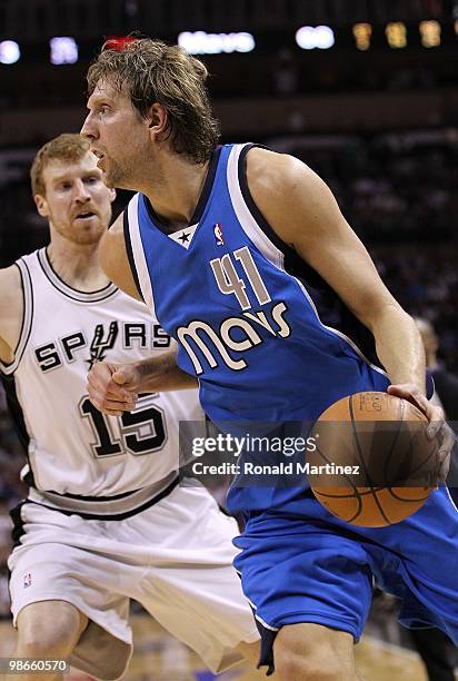 Forward Dirk Nowitzki of the Dallas Mavericks dribbles the ball past Matt Bonner of the San Antonio Spurs in Game Three of the Western Conference...