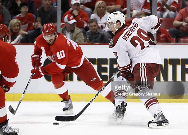 Lauri Korpikoski of the Phoenix Coyotes battles tries to control the puck in front of Henrik Zetterberg of the Detroit Red Wings during Game Six of...