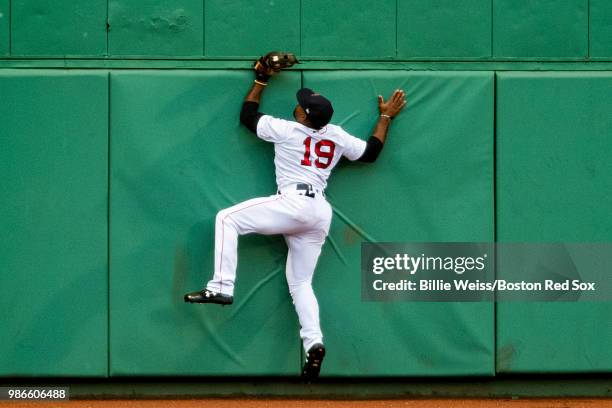 Jackie Bradley Jr. #19 of the Boston Red Sox crashes into the wall as catches a fly ball during the first inning of a game against the Los Angeles...