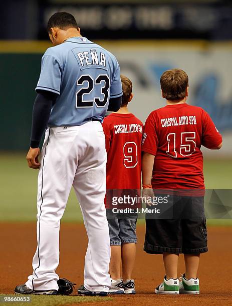 Infielder Carlos Pena of the Tampa Bay Rays stands with some little leaguers just prior to the start of the game against the Toronto Blue Jays at...