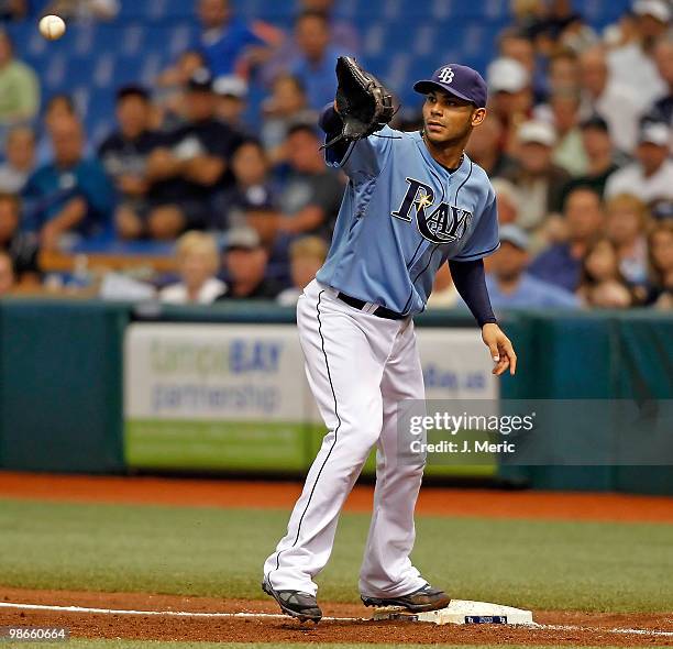 Infielder Carlos Pena of the Tampa Bay Rays takes the throw at first against the Toronto Blue Jays during the game at Tropicana Field on April 25,...