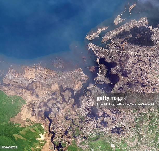 DigitalGlobe via Getty Images imagery of the the west coast of Sumatra near the capital of Aceh, Banda Aceh. It was completely destroyed by the...