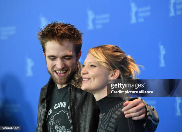 February 2018, Germany, Berlin: Berlinale 2018, photocall, 'Damsel': British actor Robert Pattinson and Australian actress Mia Wasikowska. The film...