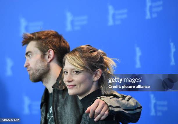 February 2018, Germany, Berlin: Berlinale 2018, photocall, 'Damsel': British actor Robert Pattinson and Australian actress Mia Wasikowska. The film...