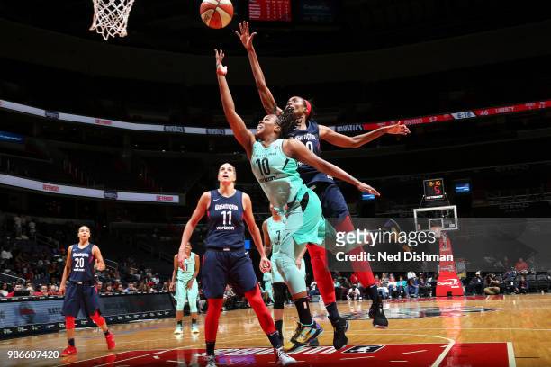 Epiphanny Prince of the New York Liberty goes to the basket against LaToya Sanders of the Washington Mystics on June 28, 2018 at Capital One Arena in...