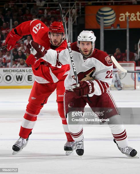 Drew Miller of the Detroit Red Wings and Lee Stempniak of the Phoenix Coyotes skate to the puck during Game Six of the Western Stanley Cup Playoffs...