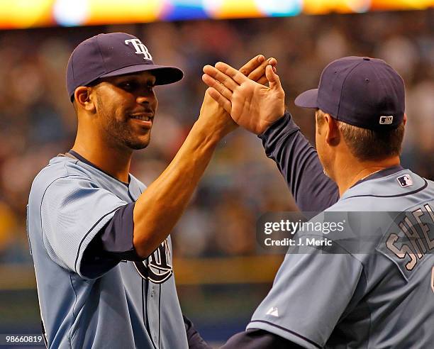 Pitcher David Price of the Tampa Bay Rays is congratulated by hitting coach Derek Shelton after his complete game shutout against the Toronto Blue...