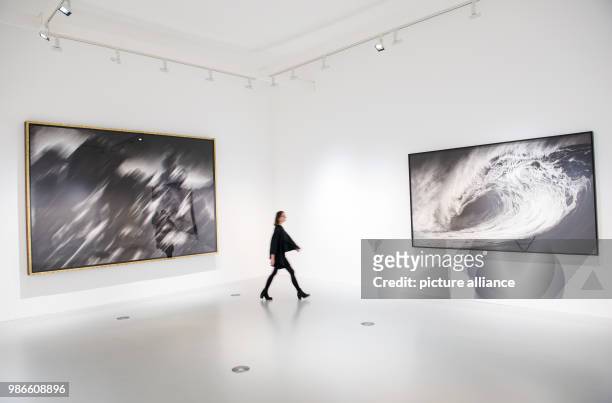 February 2018, Germany, Hamburg: A visitor walks past the exhibited art works 'Untitled ' and 'Untitled ' of artist Robert Long during a press tour...