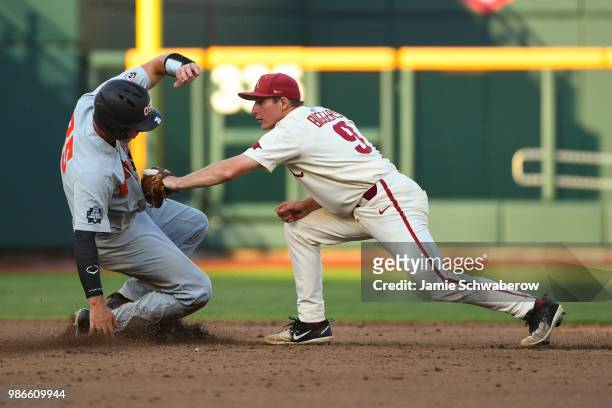 Jax Biggers of Arkansas is unable to tag out Adley Rutschman of Oregon State during game 3 of the Division I Men's Baseball Championship held at TD...