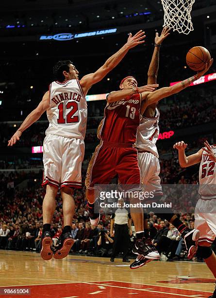Delonte West of the Cleveland Cavaliers drives to the basket between Kirk Hinrich and Derrick Rose of the Chicago Bulls in Game Four of the Eastern...