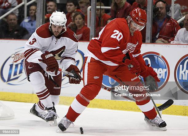 Drew Miller of the Detroit Red Wings tries to control the puck in front of Keith Yandle of the Phoenix Coyotes during Game Six of the Western...