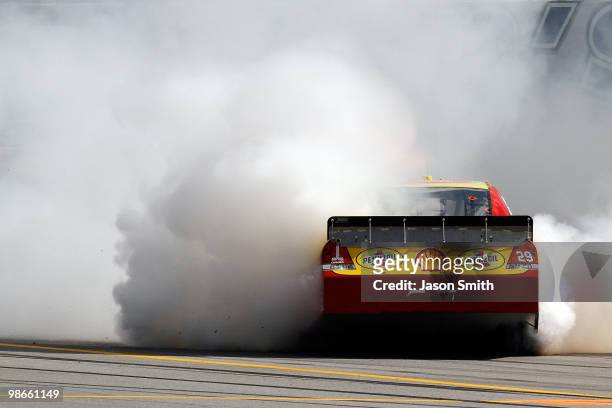 Kevin Harvick, driver of the Shell/Pennzoil Chevrolet, does a burnout on track after winning the NASCAR Sprint Cup Series Aaron's 499 at Talladega...
